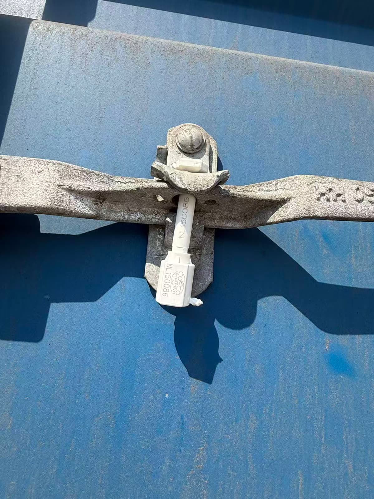 A seal on the door lock of a blue container