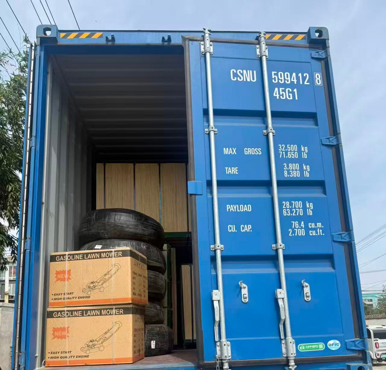 A blue container loaded with crates and cartons