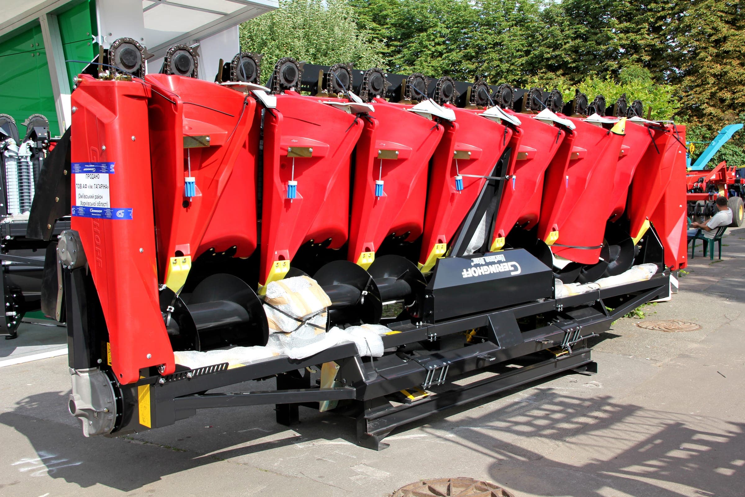 Red eight-row corn header on a trailer