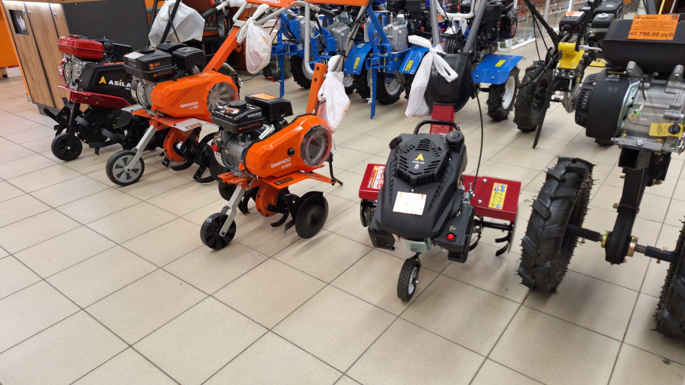 Small petrol power tillers on a showroom floor