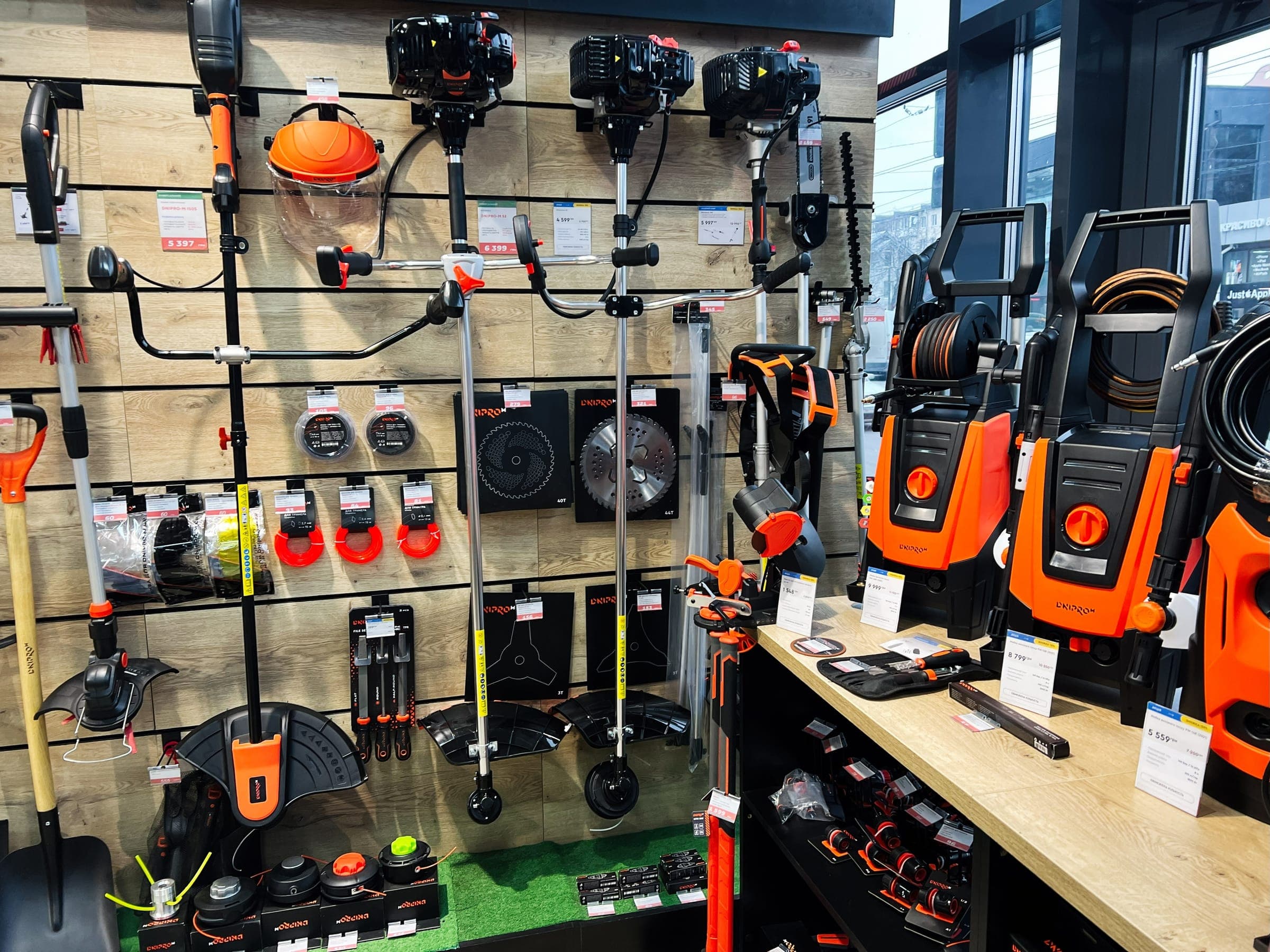 Wall of brush cutters, trimmers and pressure washers in a supply shop