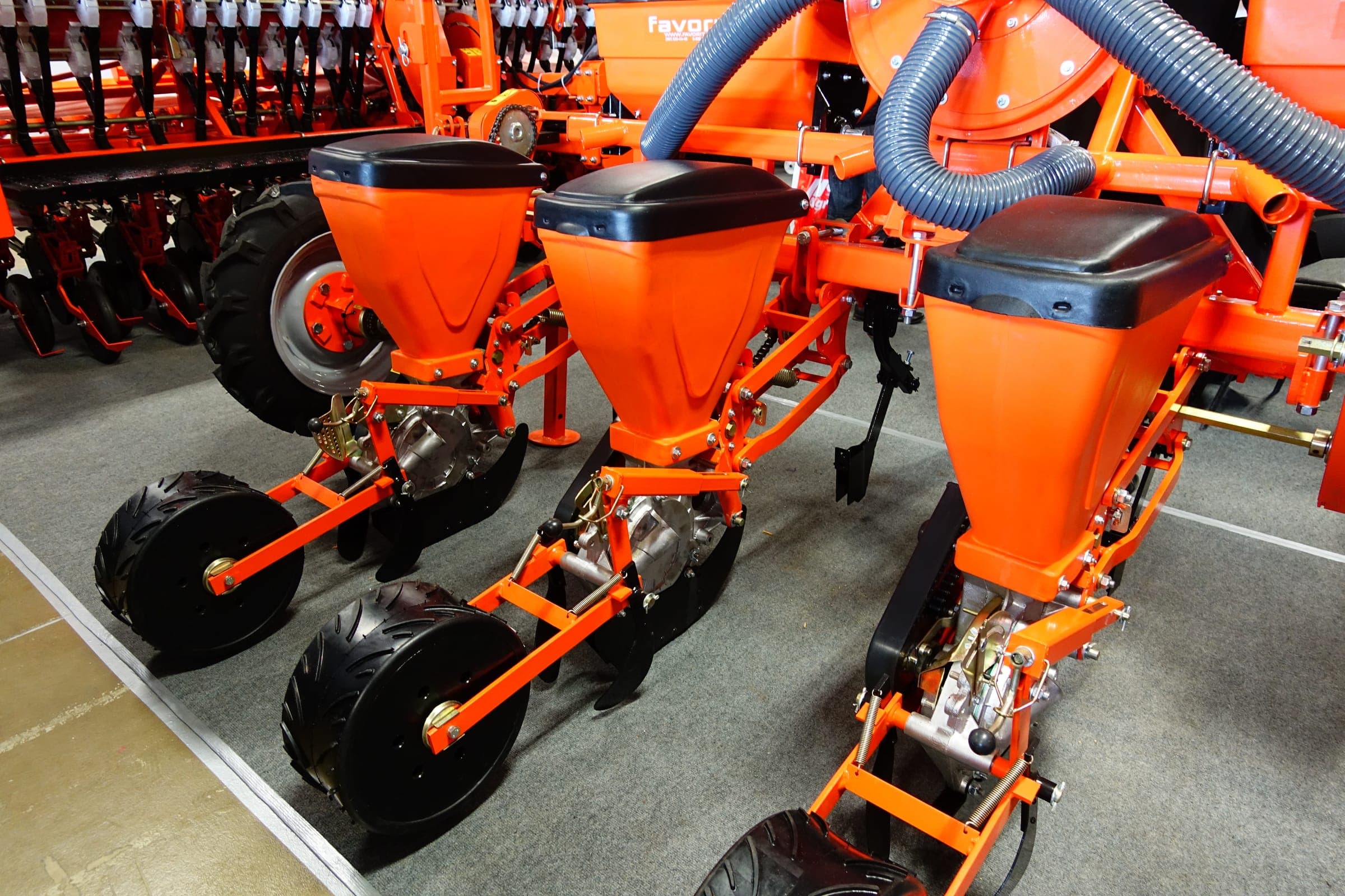 Orange precision seeders with black hoppers