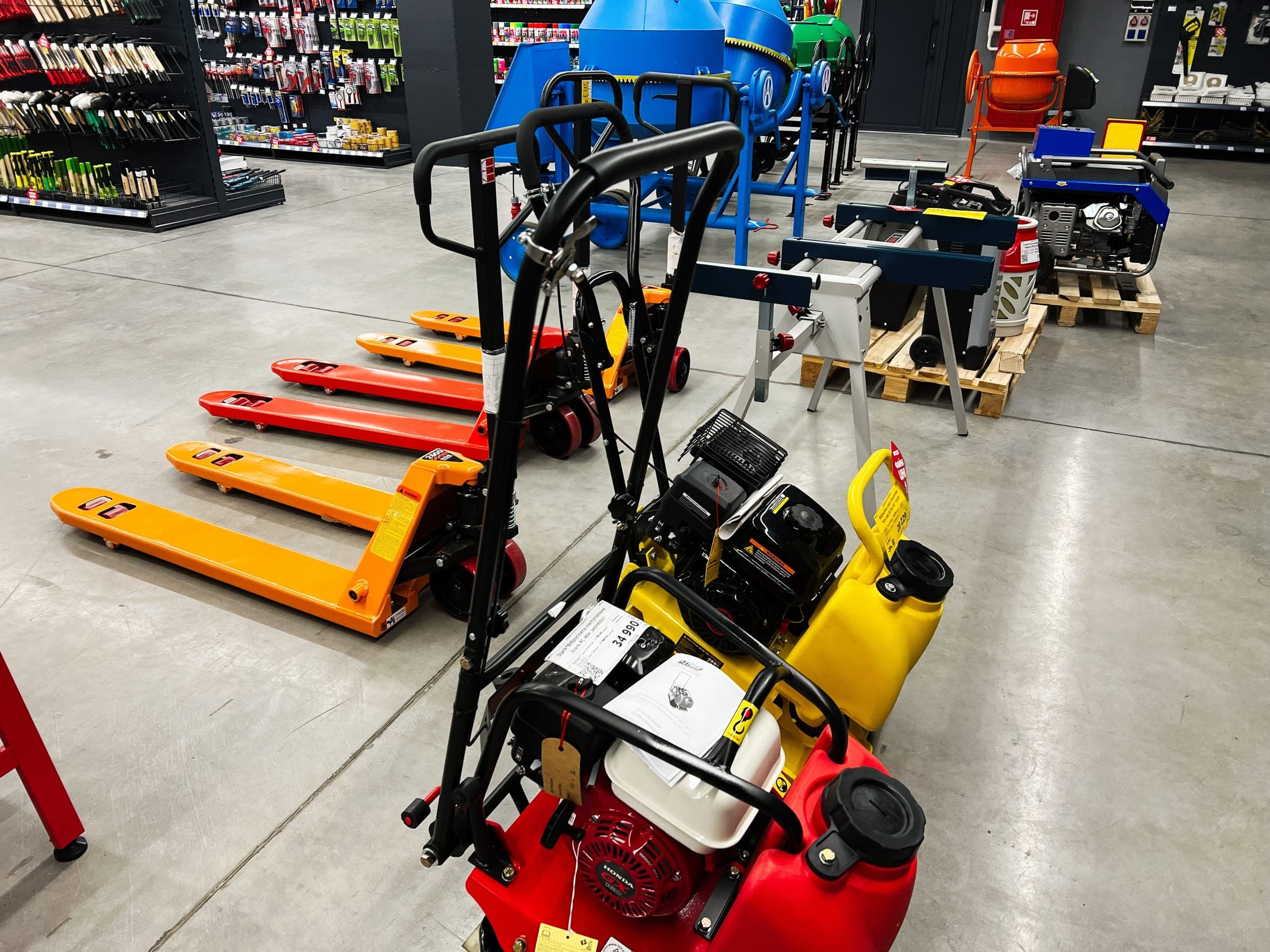 Plate compactor and pallet trucks in a supply store